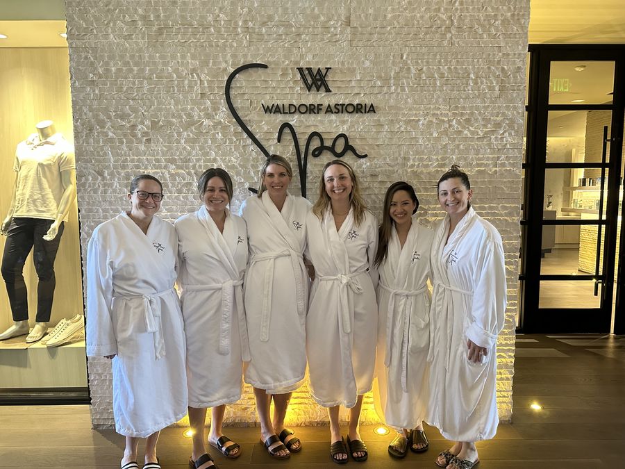 A group of friends in robes at a hotel spa